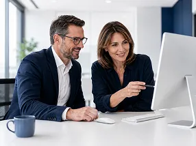 A woman and a man are sitting in an office